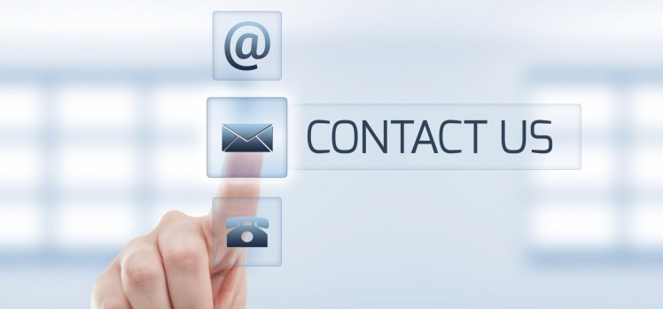 Contact us concept using woman hand touching a button. Futuristic contact us concept on light blue